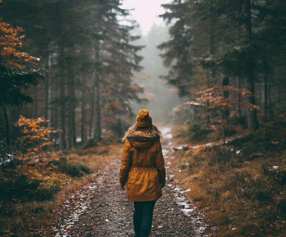 Woman walking on a forest trail in fall – sself-care rituals for women 50+